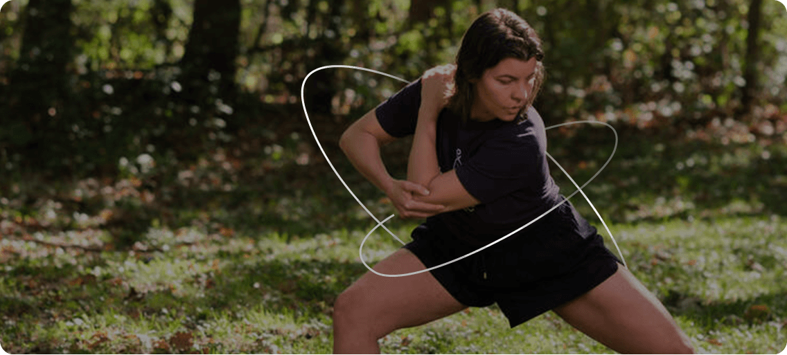 Fascial Maneuver Coach performing stretch in nature