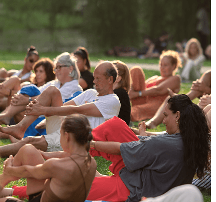 Group practicing Fascial Maneuvers together outdoors in a park